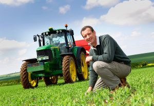 Farmer and tractor in a filed of peas