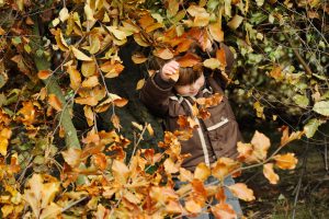 Pupil building a den in the garden