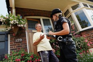 Police Officer with a resident conducting door to door enquiries