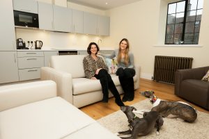 Residents in their new apartment in Midhurst