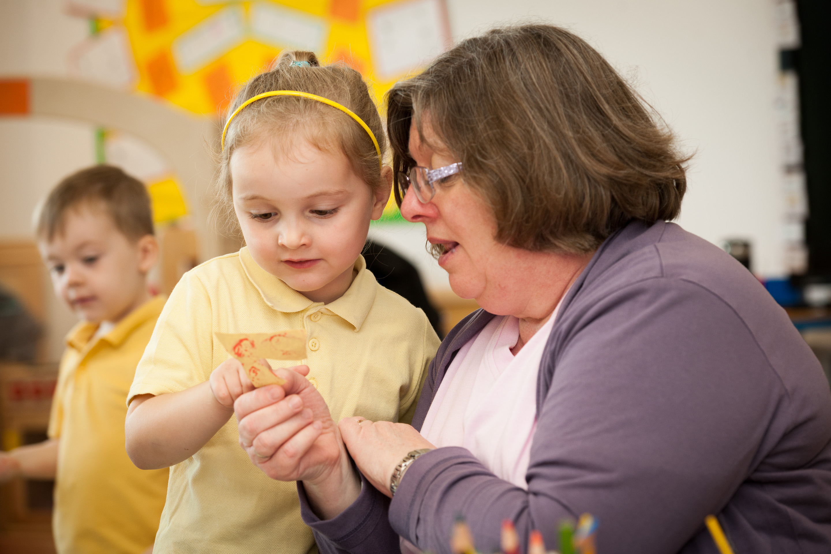 Primary school pupil with her teacher