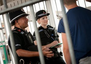 Police officers with British Rail passengers at a railway station