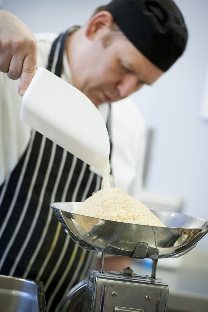 Sodexo Chef weighing rice