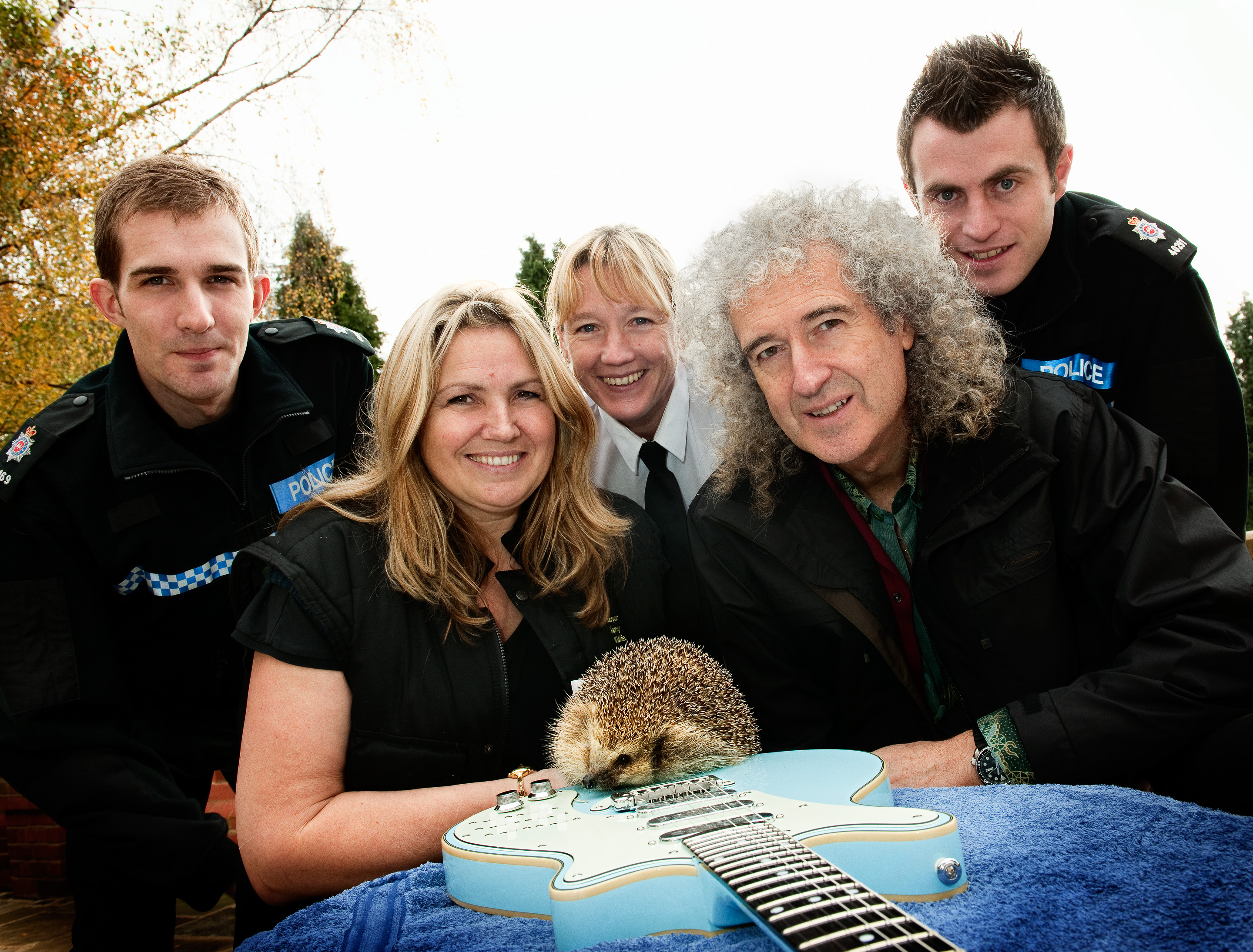 Police officers with rescued hedgehog and Brian May