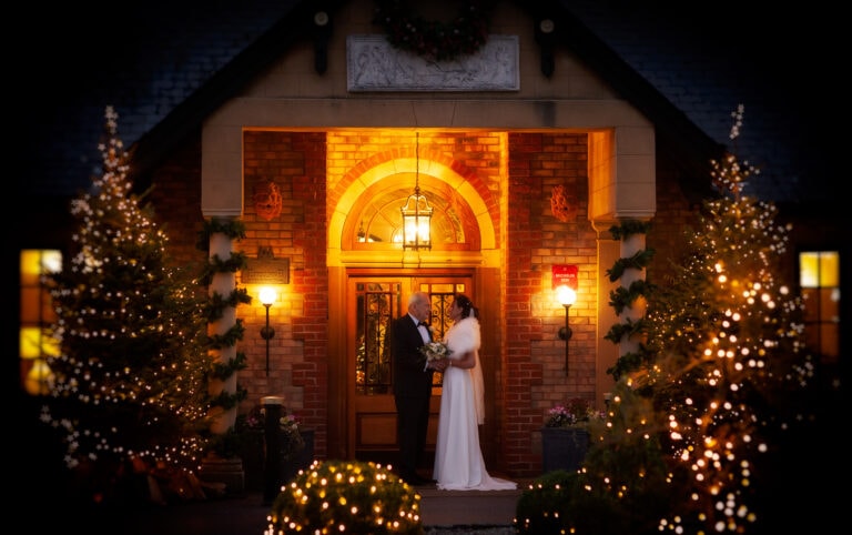 Bride and Groom outside in the evening with christmas trees