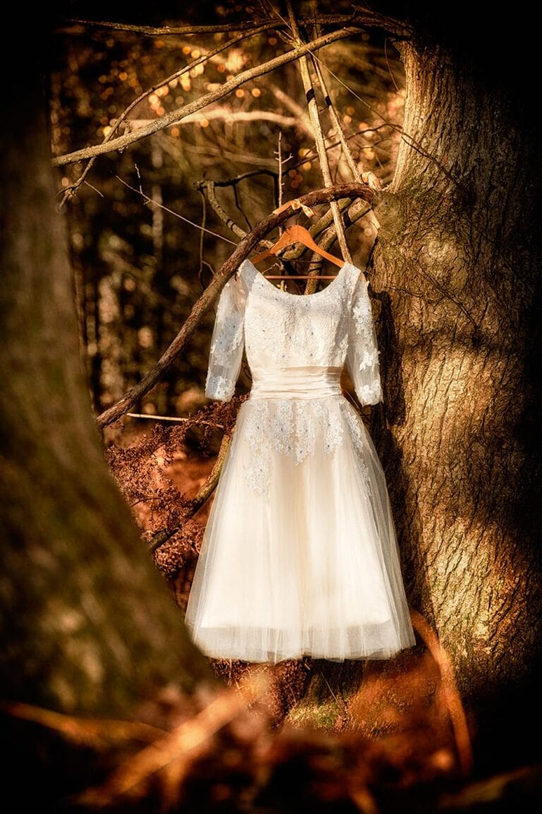 Wedding dress hanging in the woods