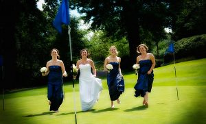 Bride running across a golf green