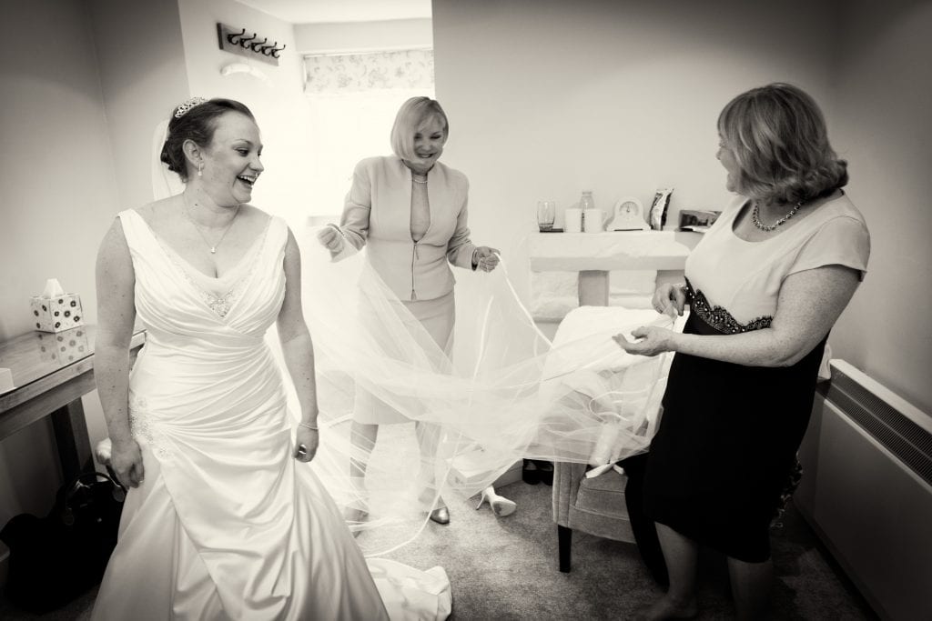 Mums helping with the brides veil at Farnham Castle