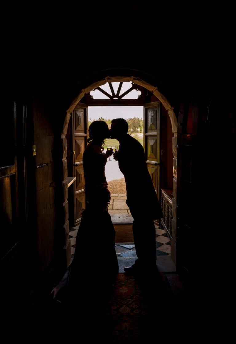 Silhouette of a bride and groom in a doorway