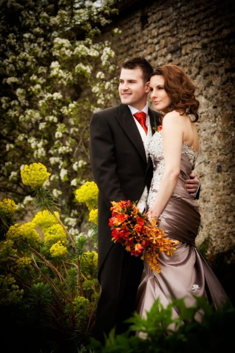 Bride and groom in a walled garden