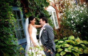 Bride and groom outside country cottage