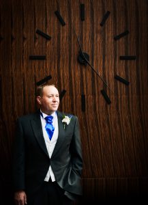 Groom by large clock at Guildford Harbour Hotel