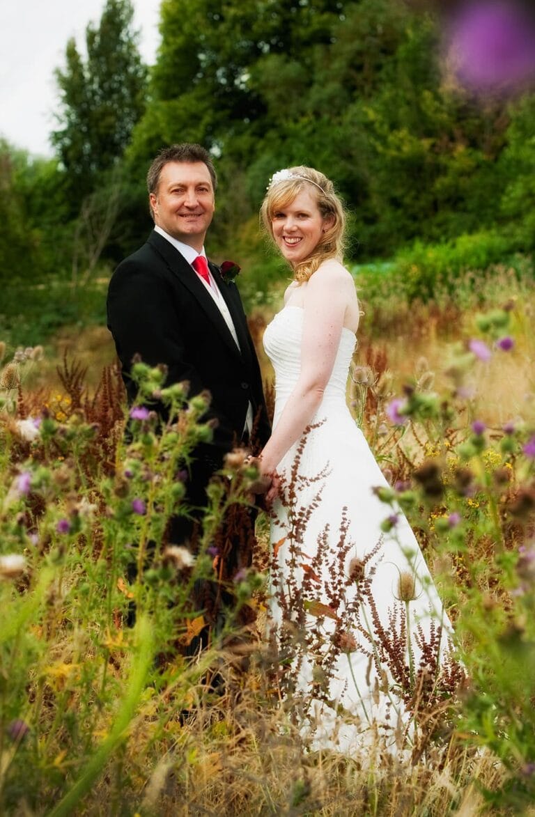 Bride and groom in a wild flower meadow