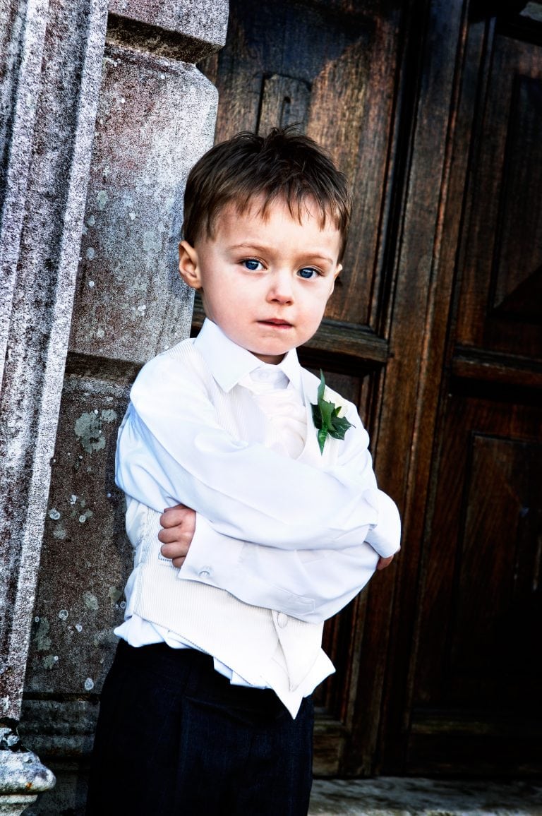 Artistic portrait of a page boy at a Guildford wedding, Loseley park