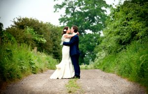 Couple kissing in a quiet country lane in the Cotswolds, Tetbury