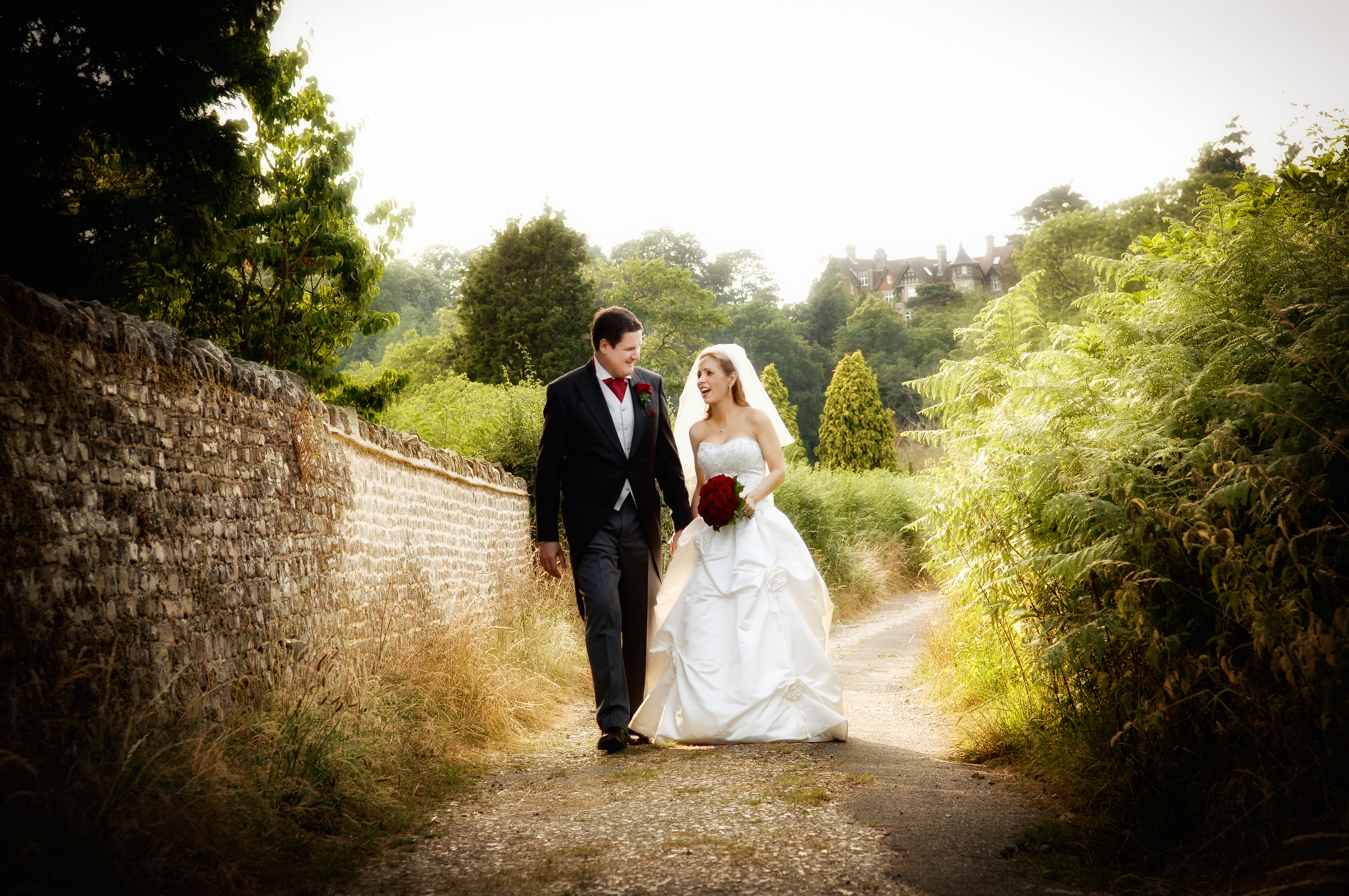 Bride and Groom walking along a country lane in Frensham