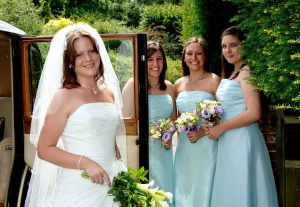 Bride and Bridesmaids by the wedding car at Hambledon, Godalming