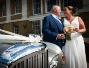 Newly weds by the Bentley wedding car