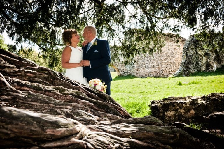 Bride and Groom at Waverley Abbey, looking over the Yew Tree roots