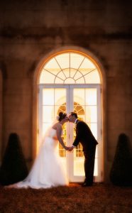 A goodnight wedding kiss outside the vine room at Northbrook Park, Farnham