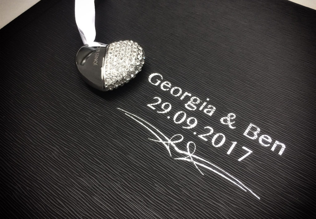 Textured album cover with silver blocking of the couples names and wedding date.