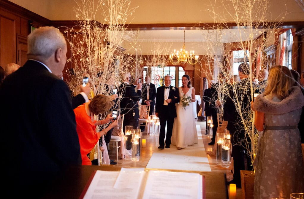 Bride walking down the aisle to her husnad-to-be at Pennyhill Park