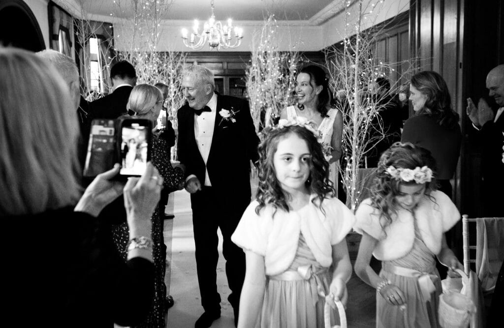 Bride and Groom walking down the aisle at Pennyhill Park