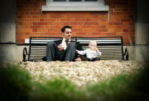 Usher and page boy sitting on a bench enjoying a drink