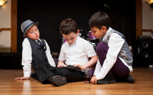 Children at a wedding reception, sitting on the floor