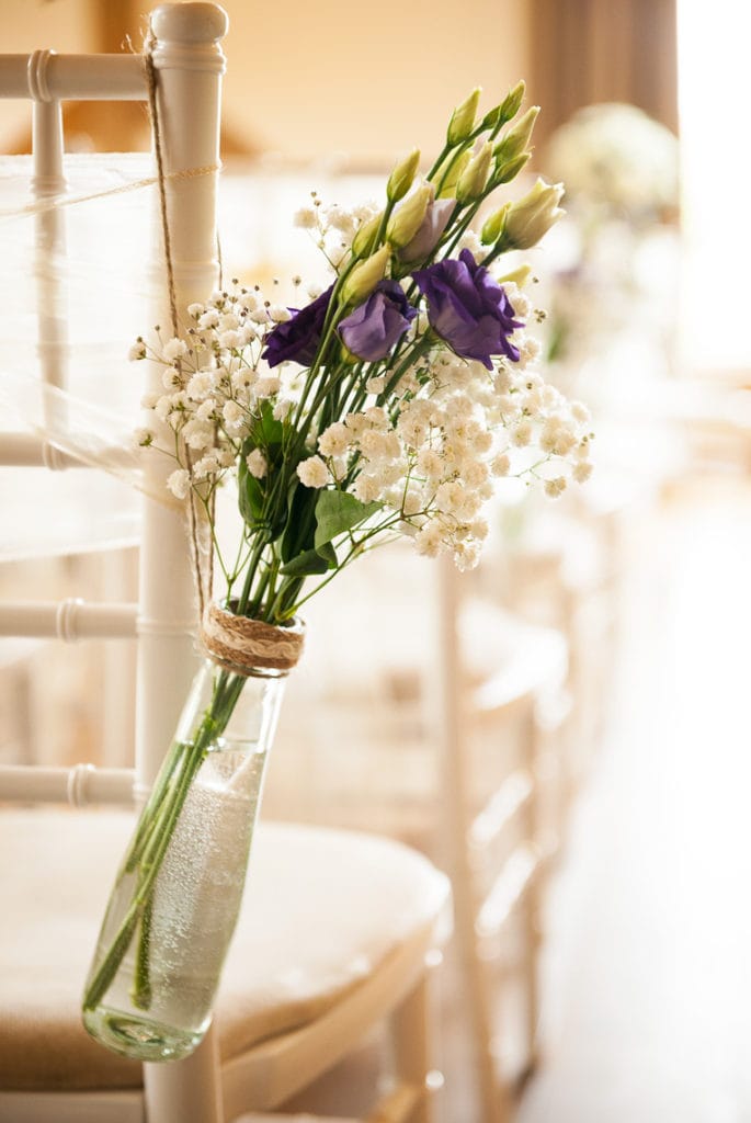 Wedding Aisle Flowers hanging on a chair