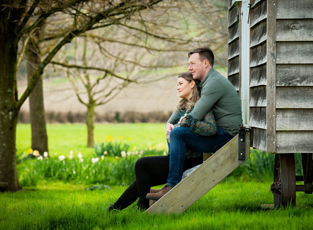 Couple sitting on the steps of a shpherds hut