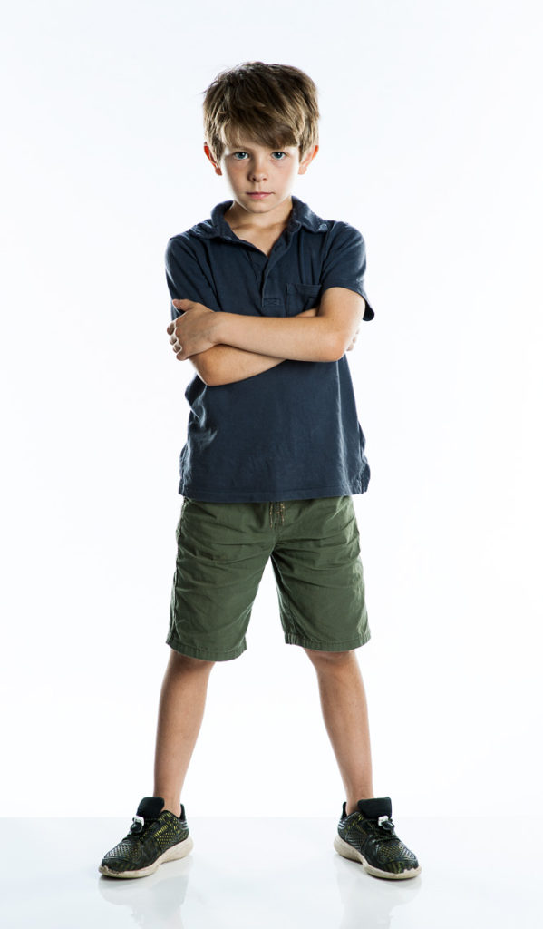 Full length studio portrait of a young bog in shorts and a T Shirt