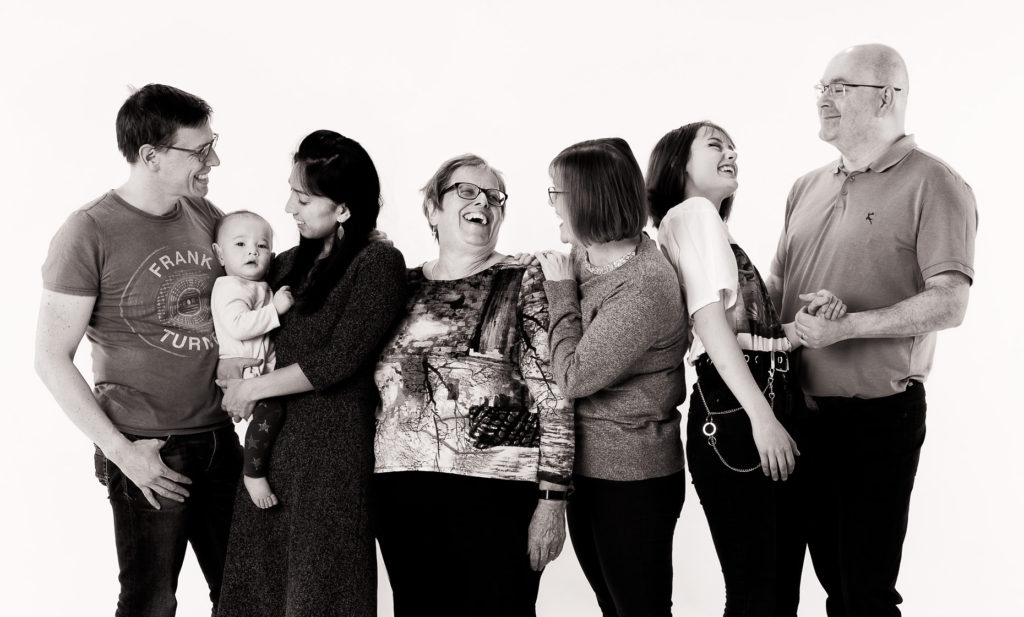 Black and white studio portrait of 3 generations of a family