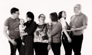 Generational studio portrait showing 3 generations