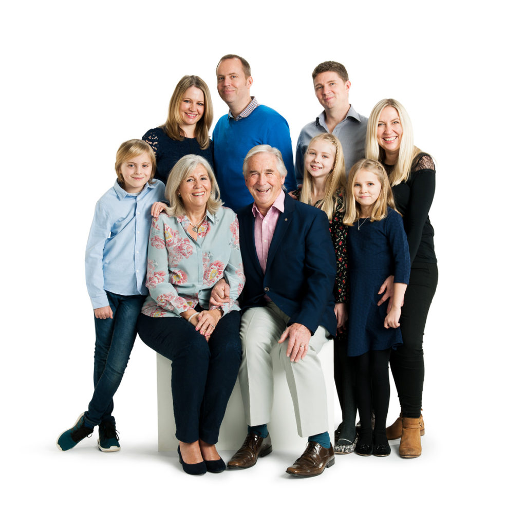 Family of 9 showing 3 generations on a white background in a studio