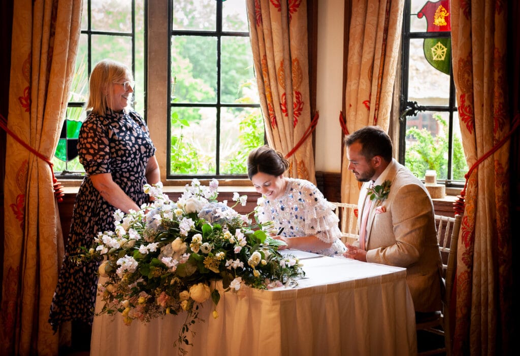 Bride and groom signing wedding register